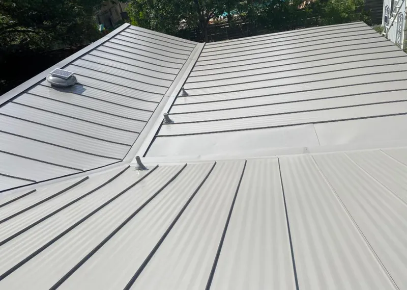 Solar attic fan installed on a metal roof for Roof Ventilation in Auburn Hills